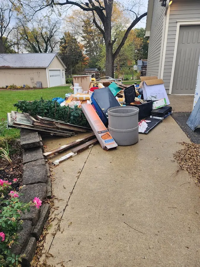 Dumpster being loaded with debris for Roofing Dumpster Rental in Wells Branch
